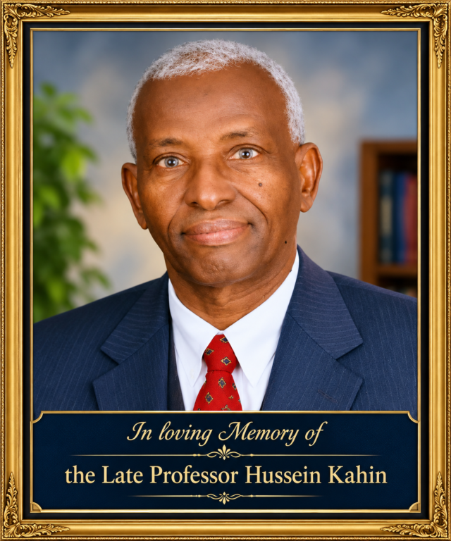 Memorial portrait of the late Professor Hussein Kahin in a gold frame, wearing a navy suit and red tie.